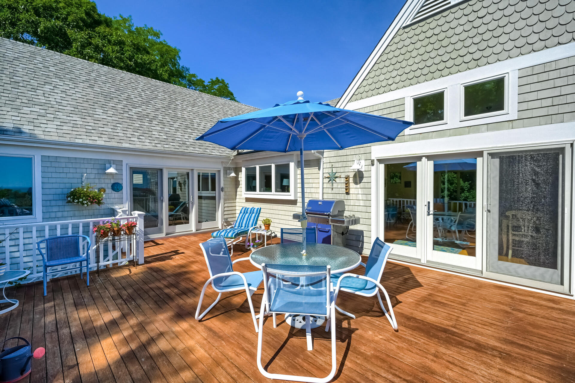 95 Chequessett Neck Road Wellfleet, MA 02667 - Photo 16 of 75 a view of a patio with a table chairs and wooden floor