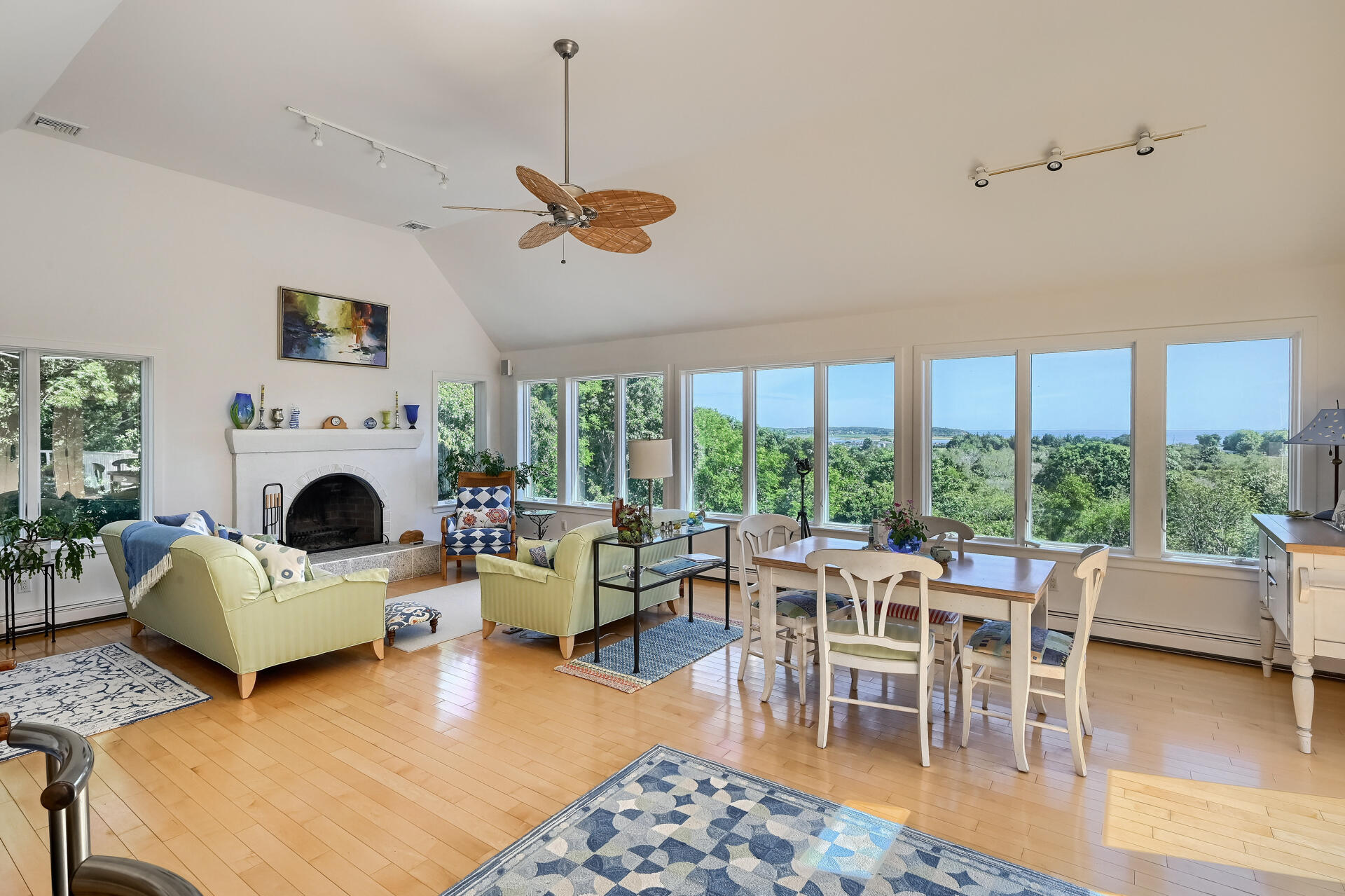95 Chequessett Neck Road Wellfleet, MA 02667 - Photo 19 of 75 a living room with furniture a fireplace and a floor to ceiling window