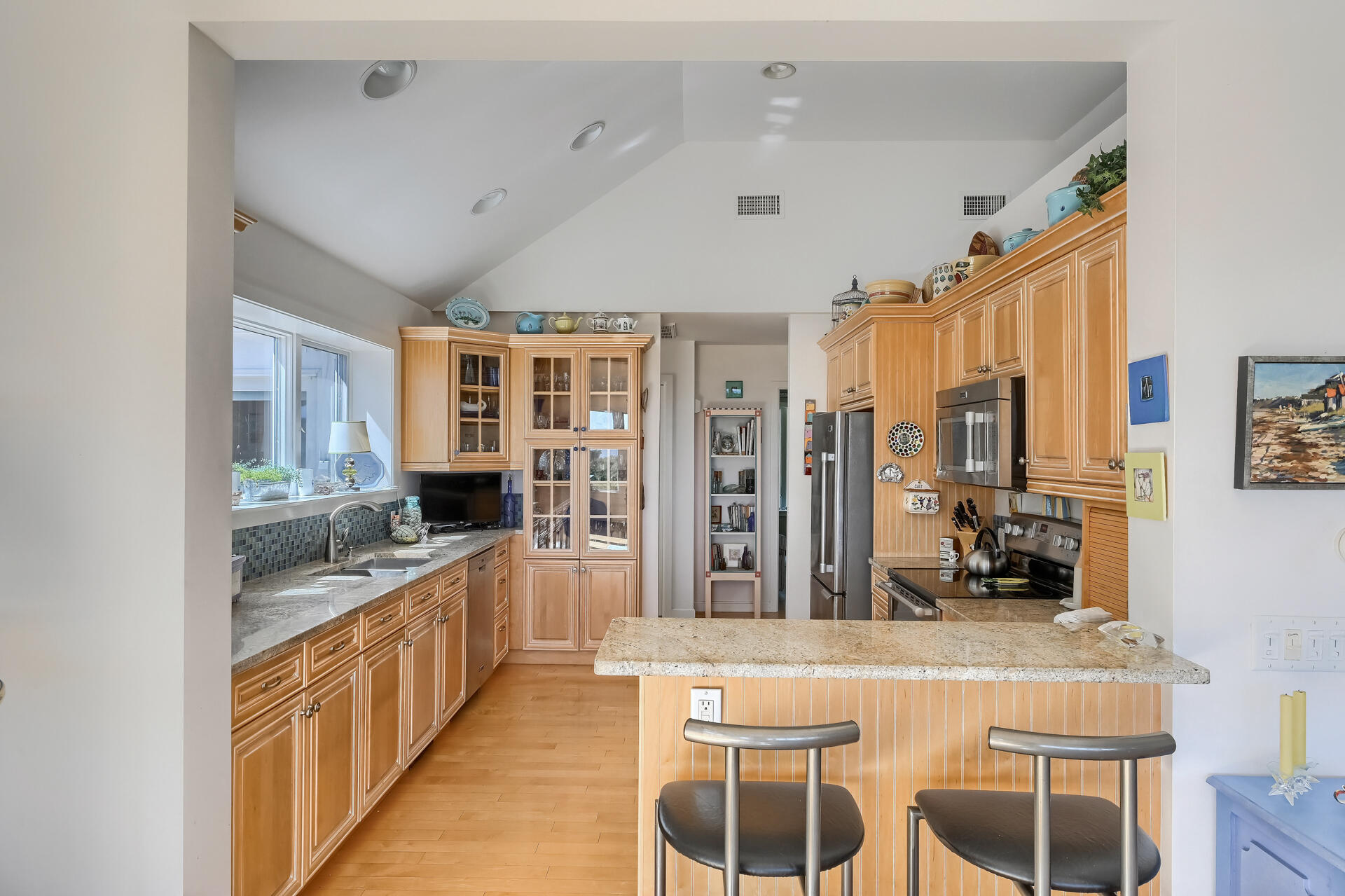 95 Chequessett Neck Road Wellfleet, MA 02667 - Photo 21 of 75 a kitchen with stainless steel appliances kitchen island granite countertop a stove and a refrigerator