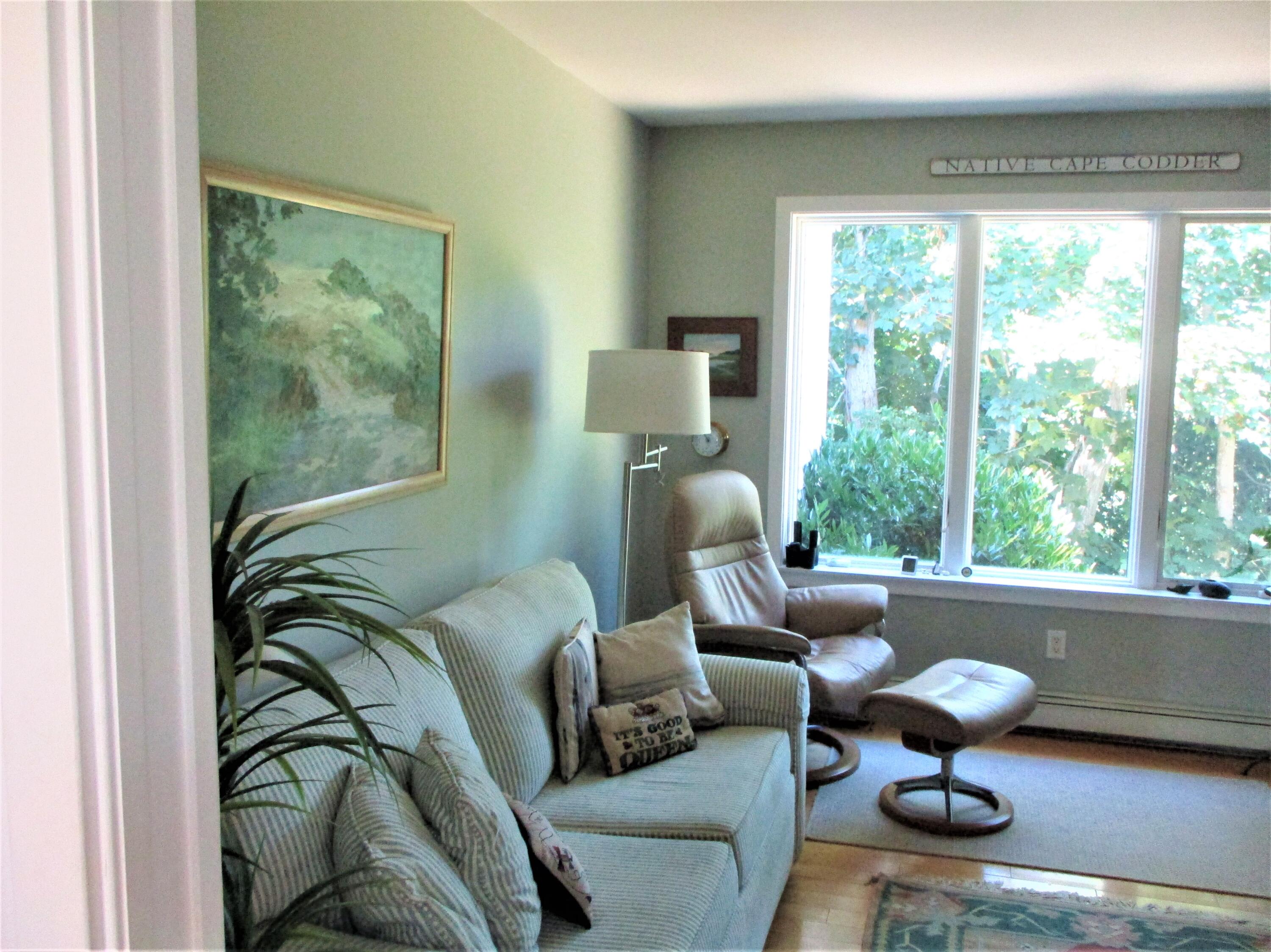 95 Chequessett Neck Road Wellfleet, MA 02667 - Photo 42 of 75 a living room with furniture and a large window