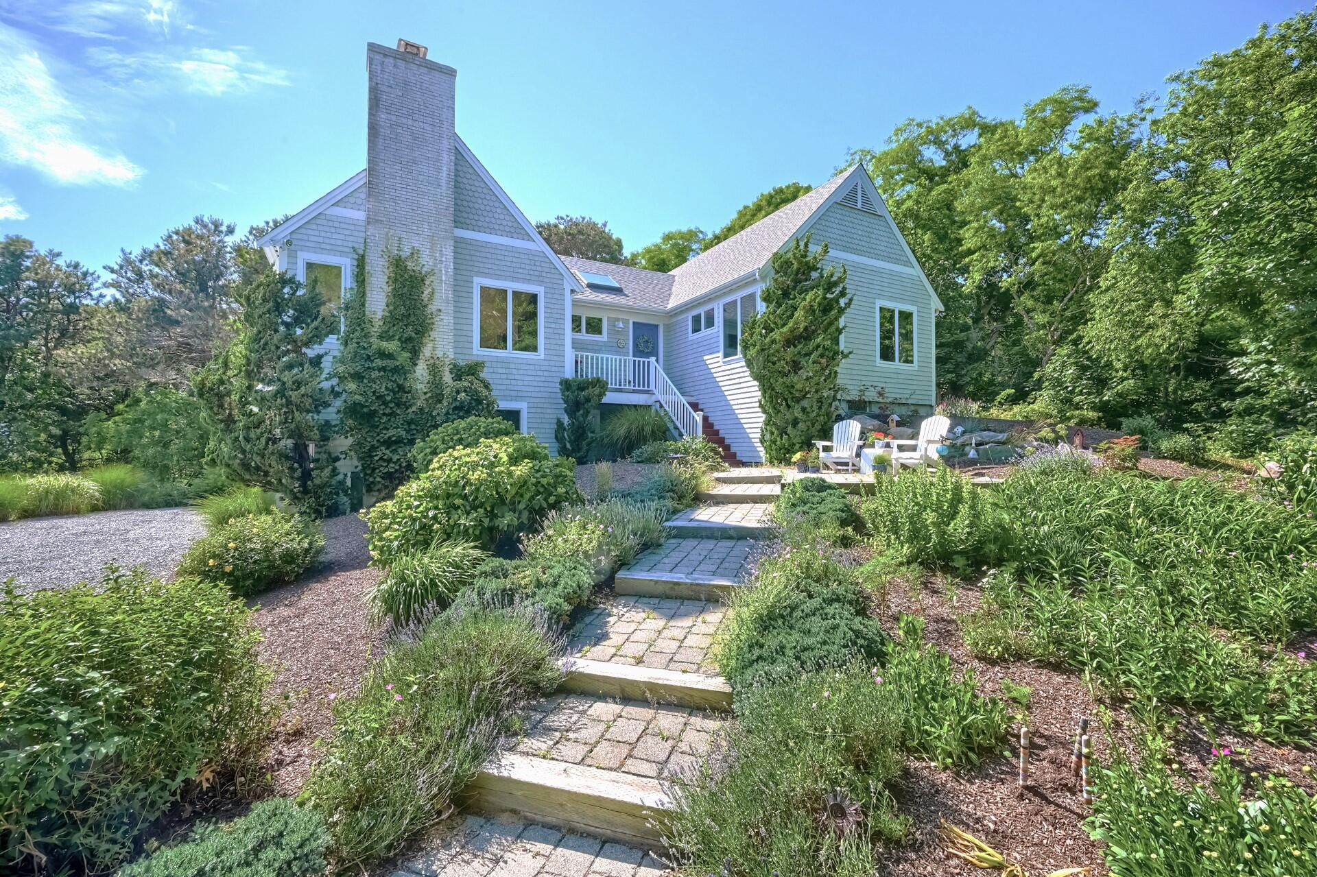 95 Chequessett Neck Road Wellfleet, MA 02667 - Photo 5 of 75 a front view of a house with a yard
