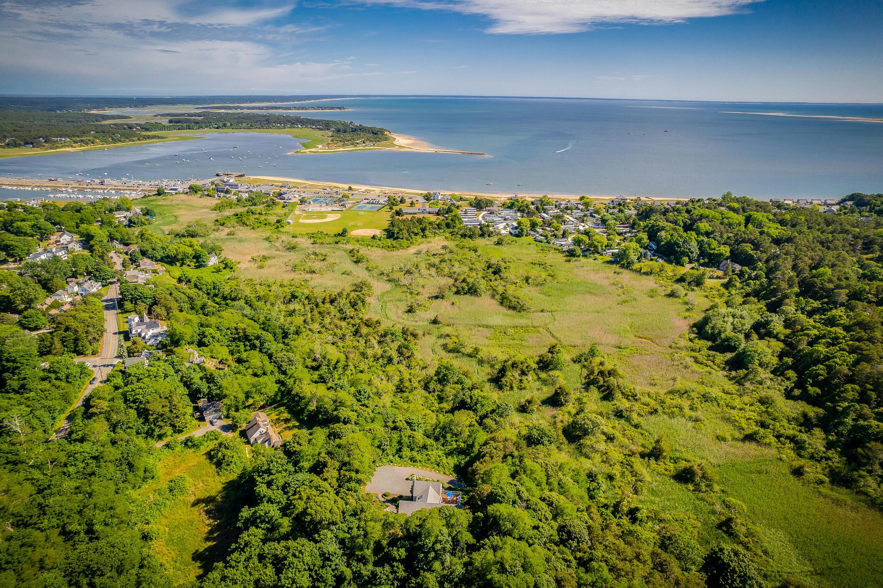 95 Chequessett Neck Road Wellfleet, MA 02667 - Photo 63 of 75 a view of a yard with a swimming pool