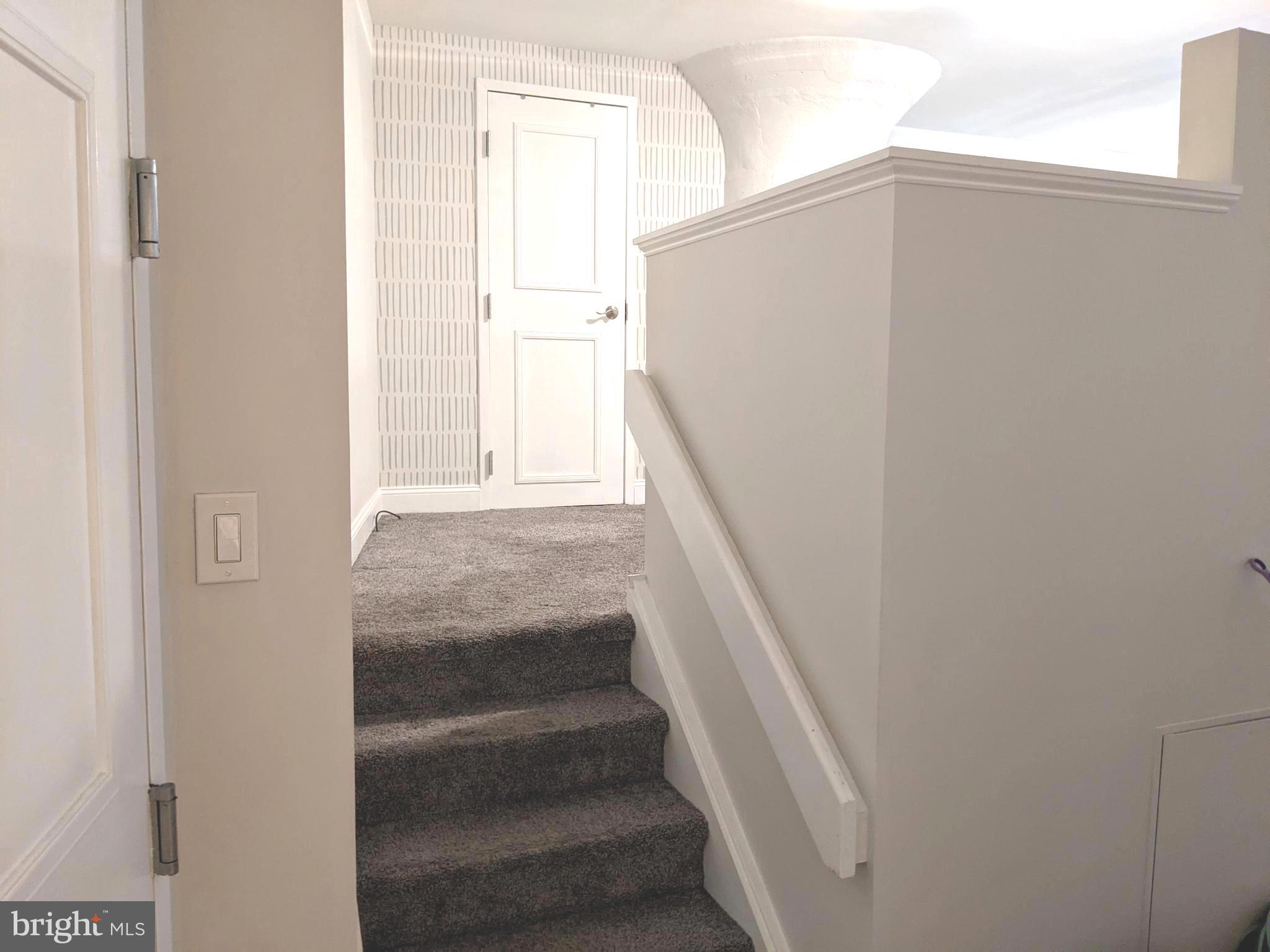 1100 South Broad Street, Unit 309B Philadelphia, PA 19146 - Photo 12 of 34 a view of staircase with white walls and white door