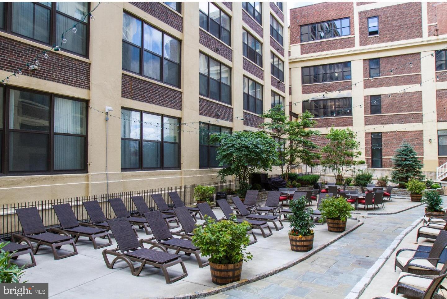 1100 South Broad Street, Unit 309B Philadelphia, PA 19146 - Photo 27 of 34 a view of a building with potted plants and flowers