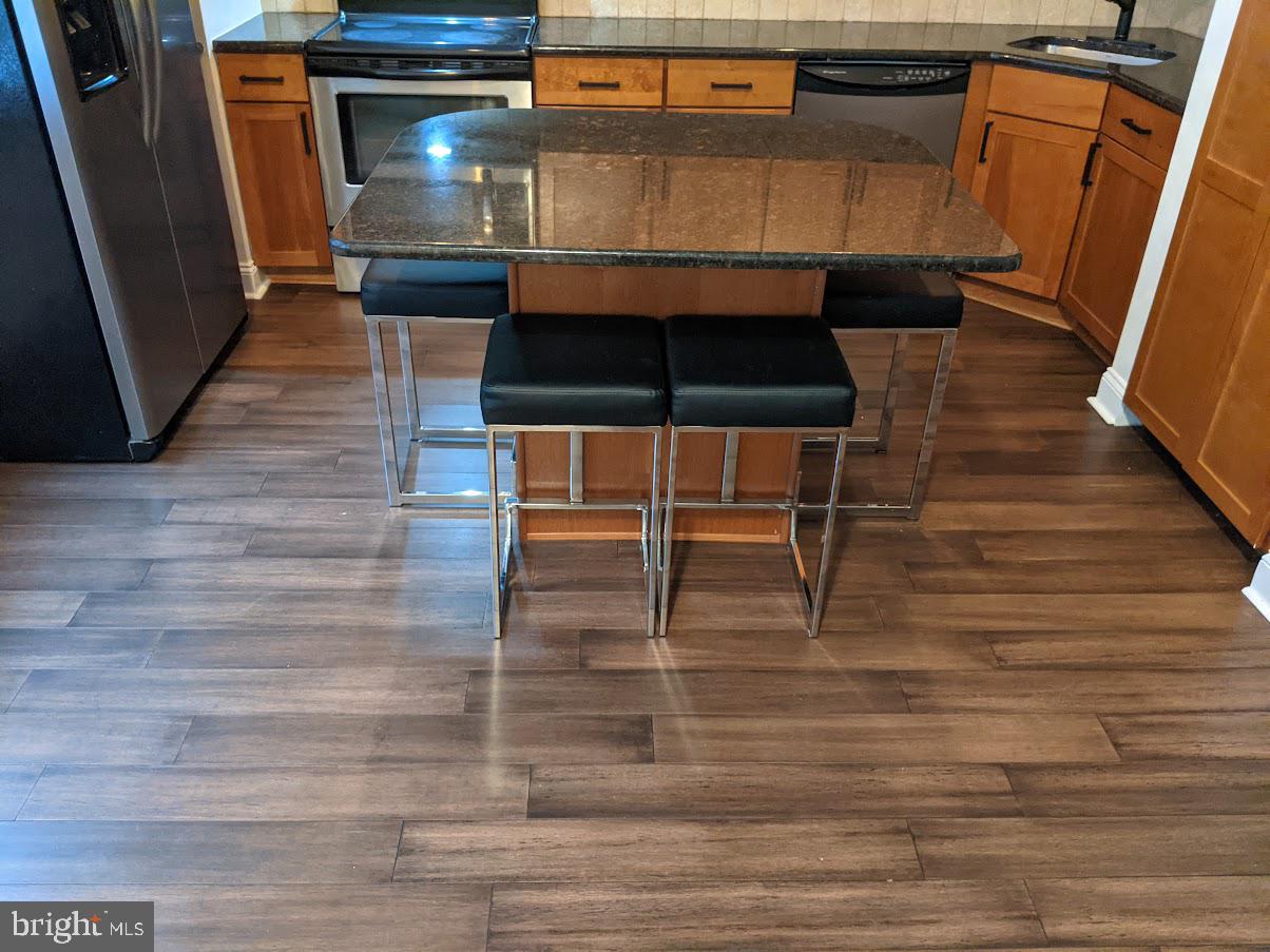 1100 South Broad Street, Unit 309B Philadelphia, PA 19146 - Photo 5 of 34 a room with wooden floor and furniture