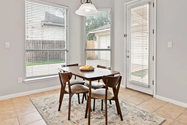 a dining room with furniture and window