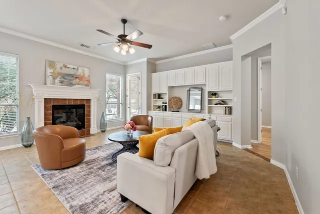 a living room with furniture a fireplace and window