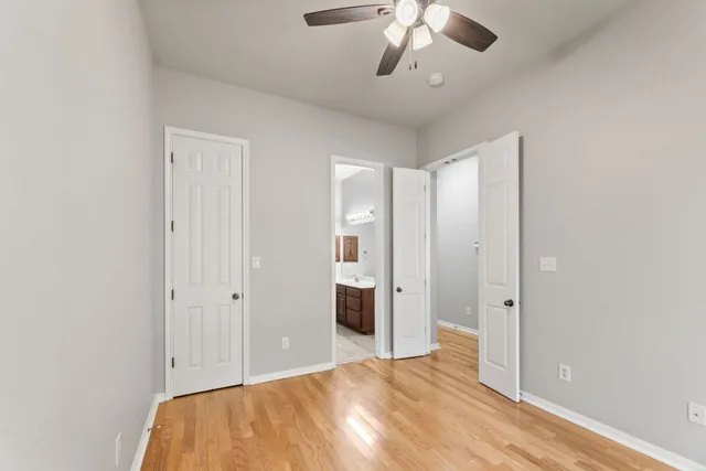 a big room with closet and chandelier fan