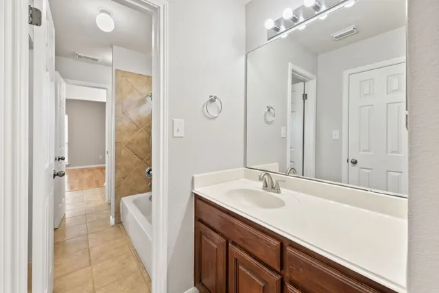a bathroom with a sink a mirror and a shower