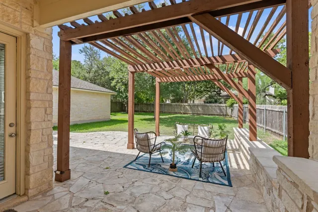 a view of a patio with a table chairs and backyard