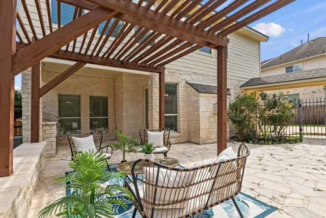 a view of a patio with couches table and chairs and potted plants