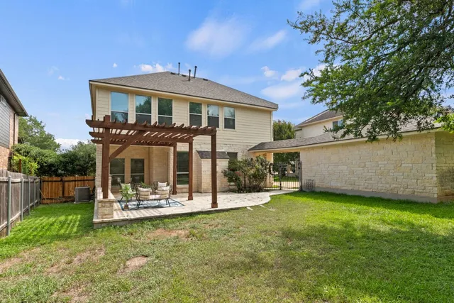 a front view of a house with a yard table and chairs