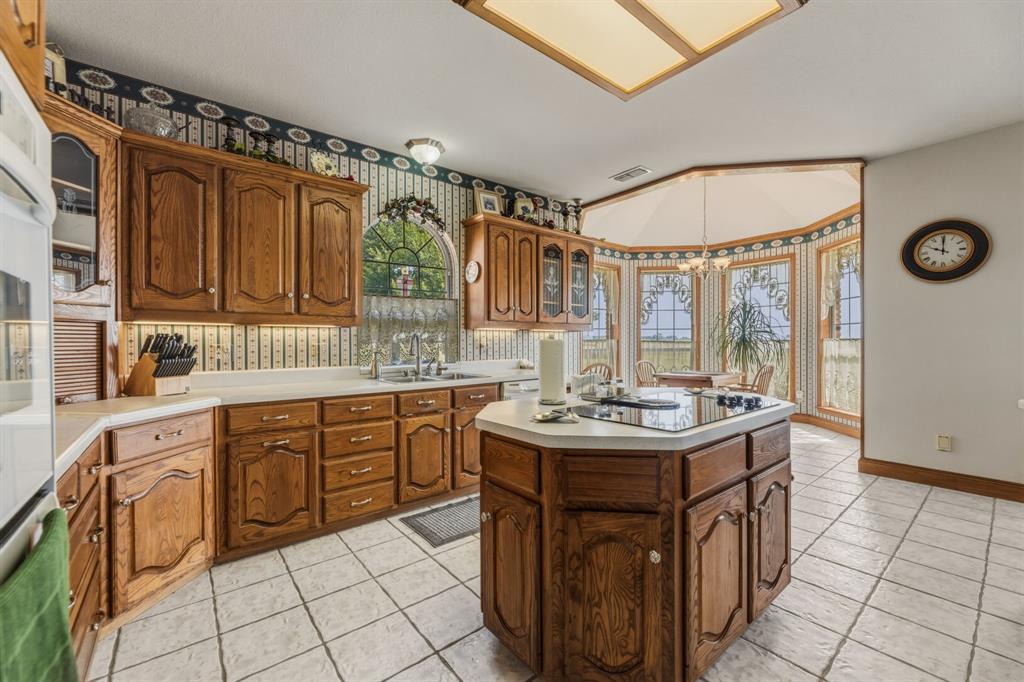 130 Blazek Road Alma, TX 75119 - Photo 14 of 34 a kitchen with a sink stove and cabinets