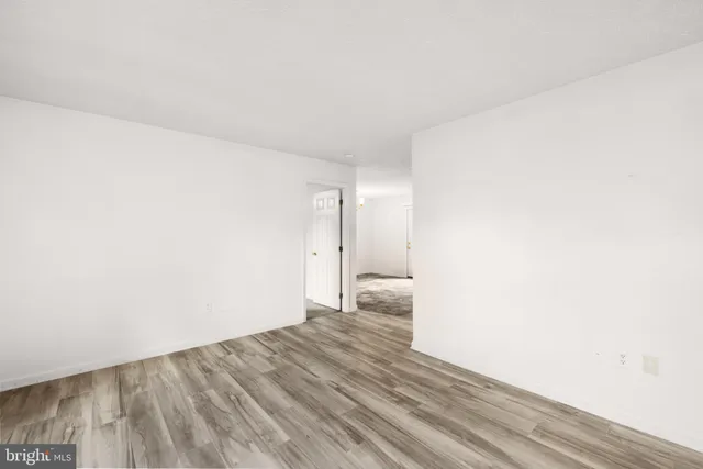a view of a room with wooden floor