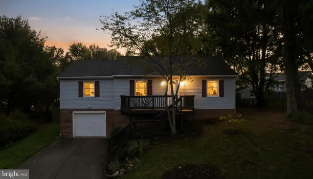 a front view of a house with a yard table and chairs