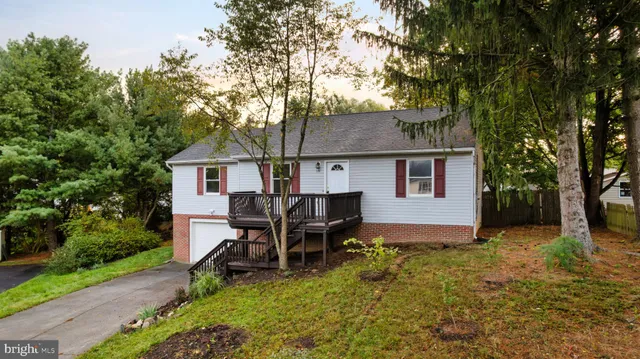 a view of a house with a yard and sitting area
