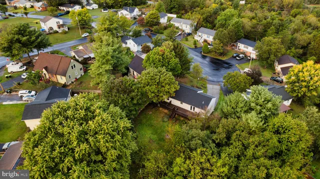 an aerial view of a house with a yard and garden