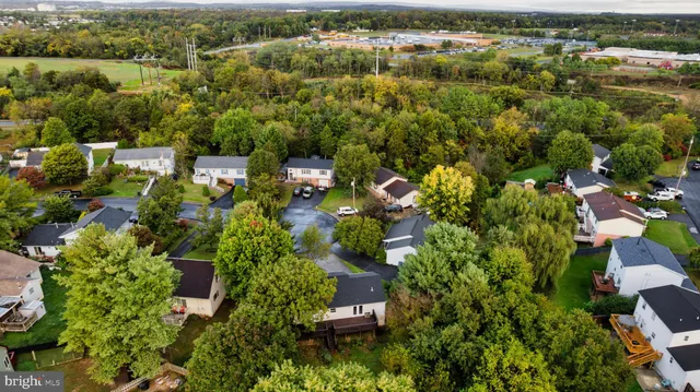 an aerial view of residential house with outdoor space and trees