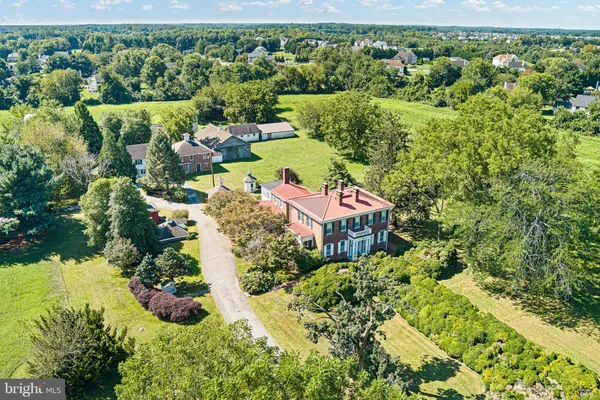 an aerial view of a house with a yard and lake view