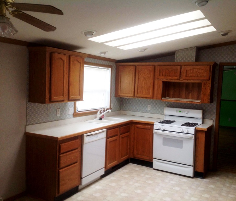 5 Medallion Road Holbrook, MA 02343 - Photo 2 of 10 a kitchen with a sink stove and cabinets