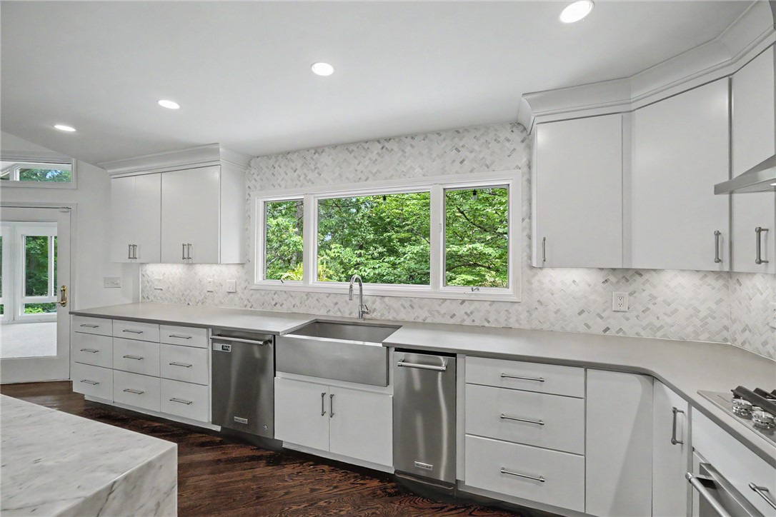 118 Beacon Ridge Circle Salem, SC 29676 - Photo 5 of 45 A well-lit kitchen with sleek cabinetry, a farmhouse sink, and views of surrounding greenery.