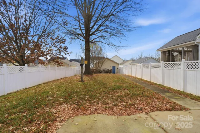 a view of road with house and trees in the background