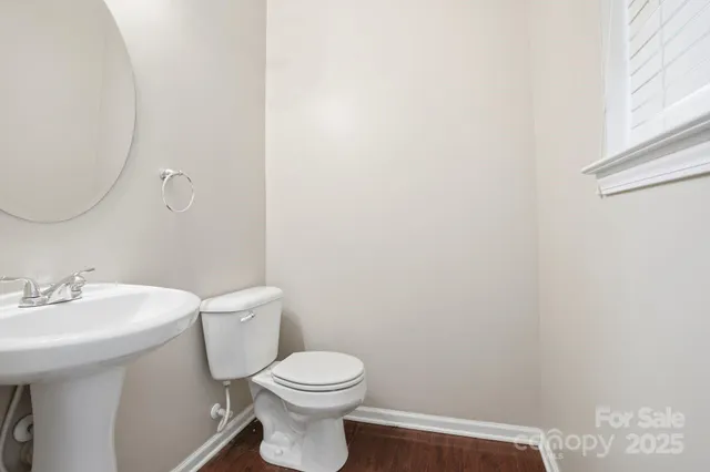 a white toilet sitting next to a bathroom sink