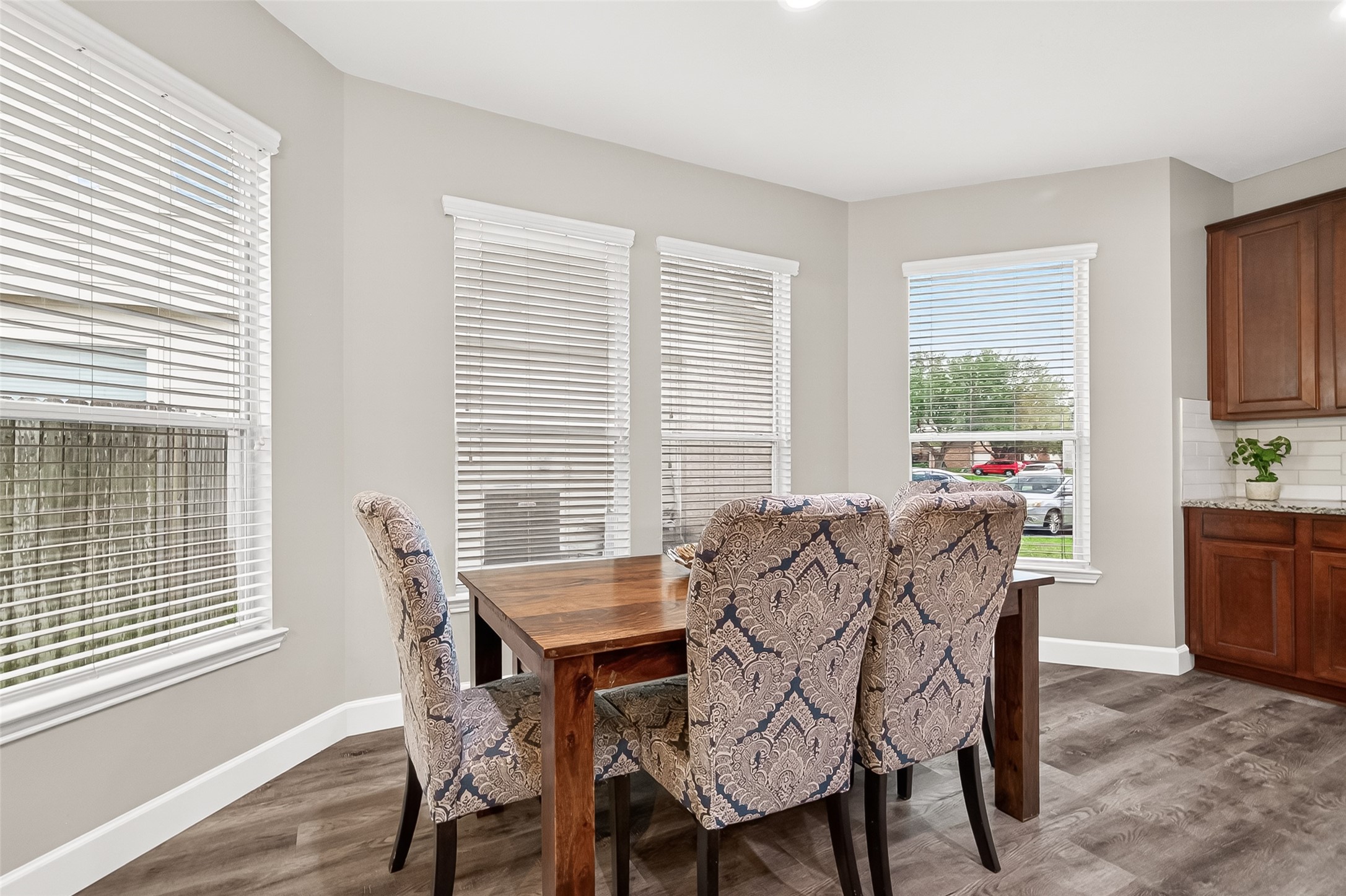 7415 Riven Oaks Court Cypress, TX 77433 - Photo 12 of 42 Bright and inviting breakfast room featuring a charming bay window that fills the space with natural light, creating the perfect spot for casual dining and morning coffee.