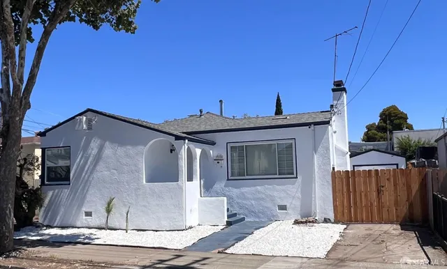 a front view of a house with sitting area