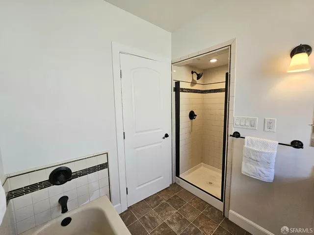 a bathroom with a shower and a sink