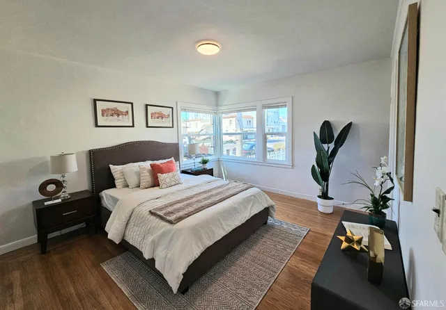 a bedroom with a bed a couch and a window