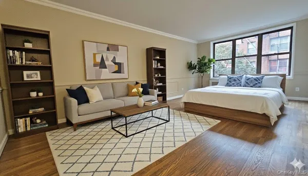 a bedroom with a bed a couch and a large window