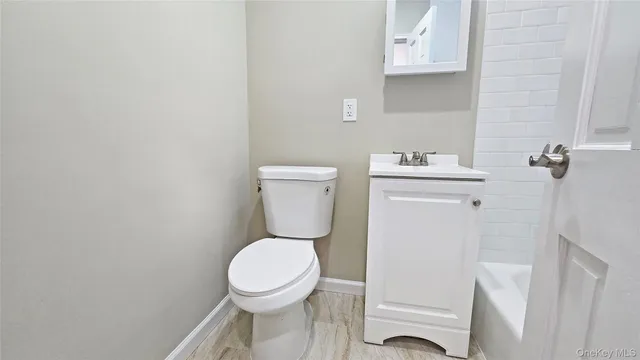 a white toilet sitting next to a bathroom sink