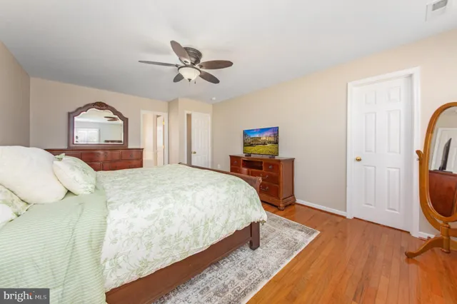 a bedroom with a bed closet and a window