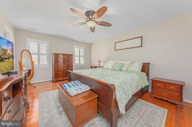 a bedroom with a bed desk and a dining table