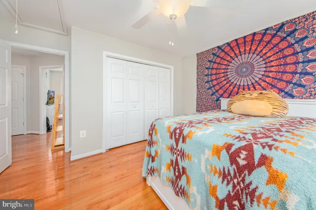 a bedroom with a bed and wooden floor