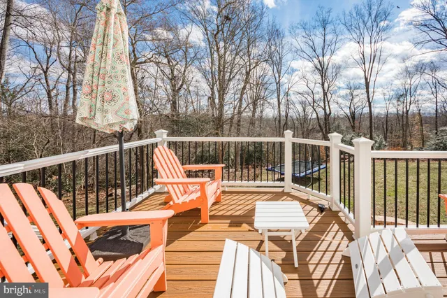 a view of balcony with wooden floor and fence