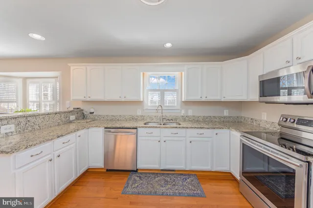 a kitchen that has a sink and a stove in it