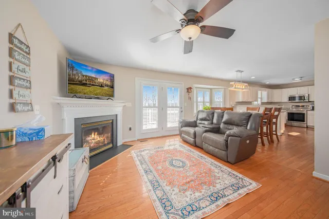 a living room with furniture fireplace and window
