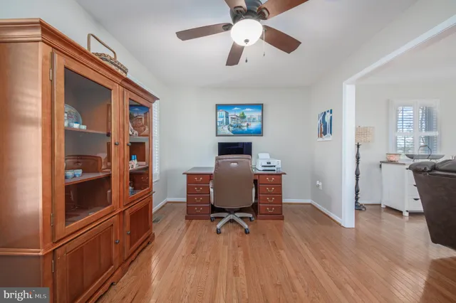 a workspace with wooden floor and furniture