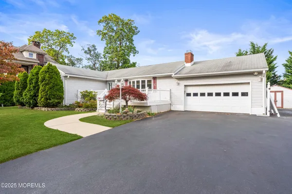 a view of a house with a yard and a garage