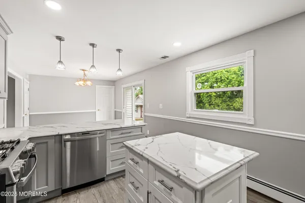 a kitchen that has a sink a stove and a wooden floors