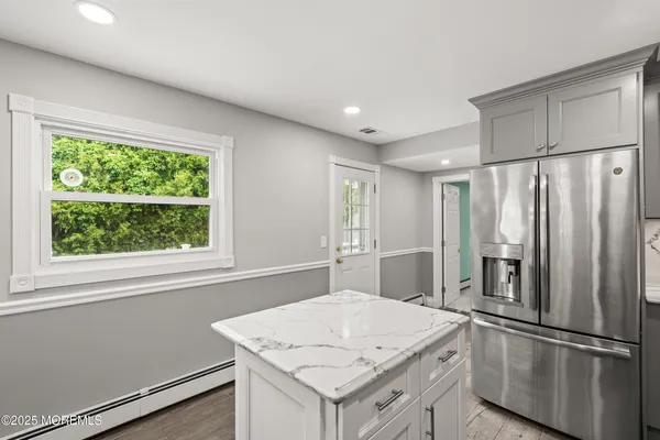a kitchen with stainless steel appliances granite countertop a refrigerator a sink and a stove
