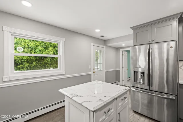 a kitchen with stainless steel appliances granite countertop a refrigerator a sink and a stove