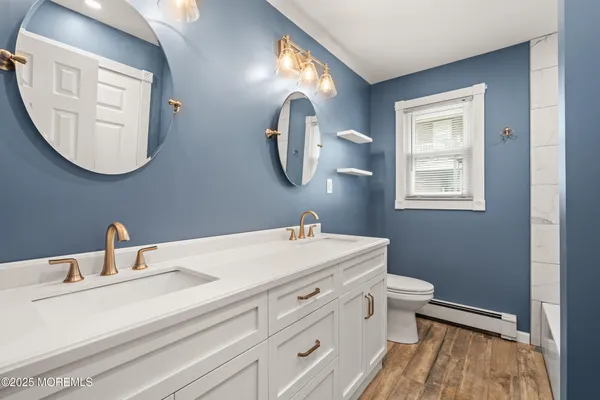 a bathroom with a toilet sink and mirror