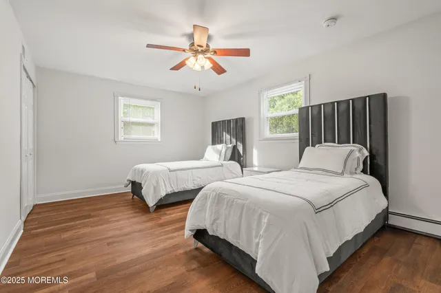 a bedroom with two beds and a chandelier