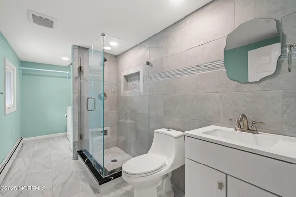 a bathroom with a toilet sink and shower