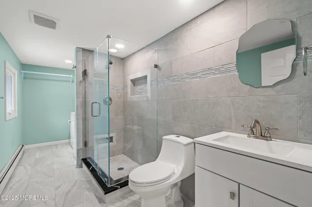 a bathroom with a toilet sink and shower