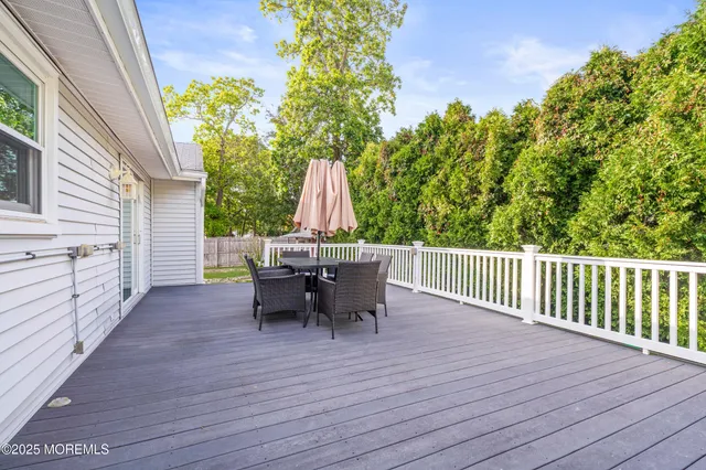 a view of a deck with furniture and a backyard