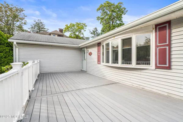 a view of a house with a wooden deck